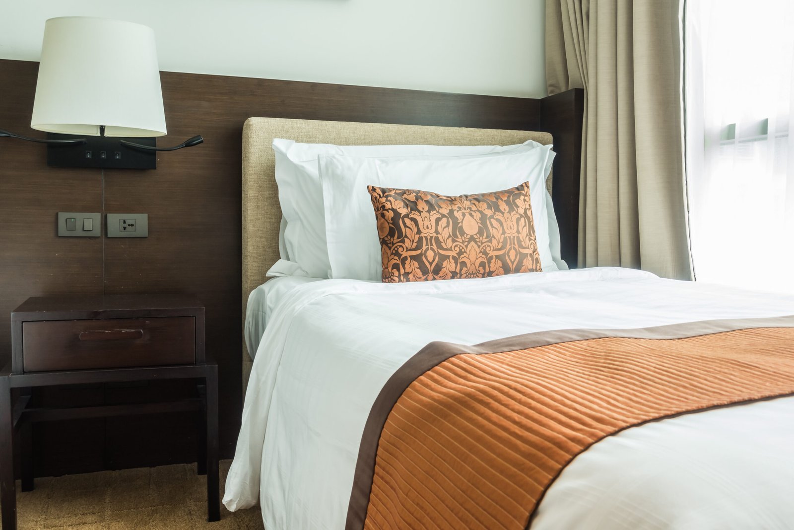 White pillow on bed decoration in bedroom interior with table light lamp